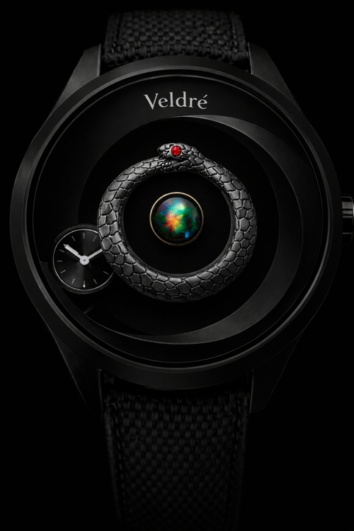 Dominus Veldré watch with black circular case, matte black void dial, black opal centre and ouroboros serpent with ruby eye.