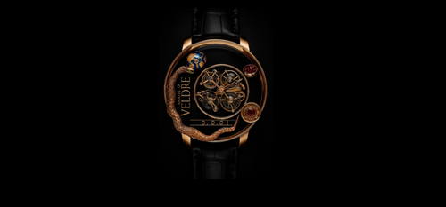 Front view of the Amaramia Veldré watch with gold circular case, exposed tourbillon, sculpted serpent dial and ruby accents.